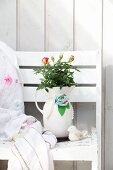 Bouquet of roses in china jug decorated with fabric flower