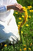 Woman making dandelion wreath