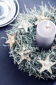 Birch bark stars wrapped in silver wire threaded with beads decorating wreath of silvery green barbed wire plant