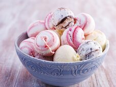 A bowl of various different scoops of ice cream