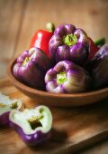 Purple and Red Bell Peppers in a Wooden Bowl