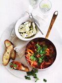 Piperade with curd cheese and slices of baguette