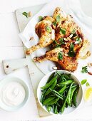 Fried chicken with yoghurt and tahini dressing, lemons and mint