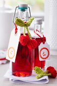 Cherry liqueur in little bottles decorated with crocheted cherries and stamped labels
