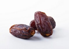 Three Prunes on White Background