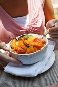 Fish and mussel soup with pumpkin and pepper on a bed of rice