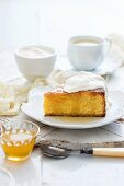 A slice of polenta cake with syrup and cream