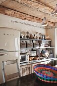 Kitchen with retro fridge and shelves of storage baskets above kitchen counter