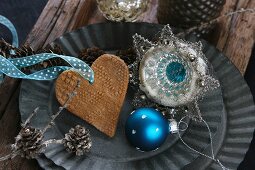 Christmas decorations for the tree: a blue bauble, a salt-dough heart and vintage hanging decorations