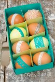 Easter eggs with coloured lace trim in blue paper box