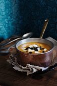 Pumpkin and parsnip soup with sheep's cheese and roasted pumpkin seeds