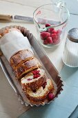 Lime Swiss roll with a raspberry and mascarpone filling, partially sliced