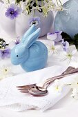 Easter table decoration with china rabbit, flowers & china egg