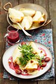 Pears topped with Taleggio and baked, served with a grape sauce and rocket