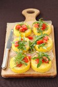 Polenta cakes with rocket and tomatoes