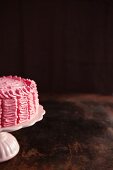 Raspberry layer cake on a cake stand (section)