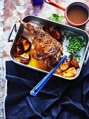 Roasted leg of lamb with peas and a red wine sauce
