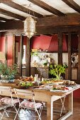 Large kitchen-dining room with wooden table in French country house