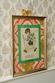Hand-crafted decoration for child's bedroom on retro wallpaper - vintage postcard with washi tape and 70's wallpaper mount in old metal picture frame