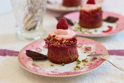 Mini raspberry cheesecakes with chopped pistachios