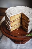 Rosemary Corn Cake with Brown Butter and Honey Buttercream Frosting on a Wooden Cake Plate