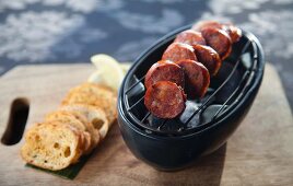 Grilled chorizo slices with toasted bread