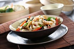 Wide oriental noodles with vegetables and prawns