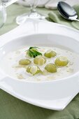 Ajoblanco (cold garlic and almond soup, Spain) garnished with grapes