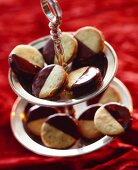 Chocolate-dipped biscuits on a tiered cake stand