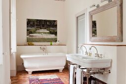 A traditional tomette tiled floor in white bathroom with artwork by Martini Maggi