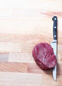 Raw beef fillet steak with a knife