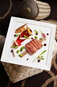 Fried duck breast with cherry sauce and spring vegetables