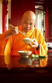 A monk eating