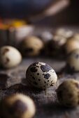 Several quail's eggs on a wooden surface