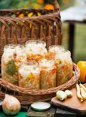 White cabbage and carrot salad with red peppers in jars