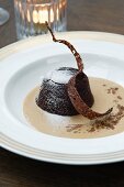 Chocolate pudding with icing sugar in coffee sauce