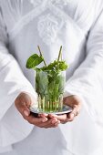 Woman holding drink in cupped palms