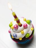 A Decorated Cupcake with a Candle
