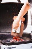 Pouring Hot Coals onto Barbecue