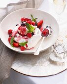 Bowl of pavlova with cranberries and raspberries