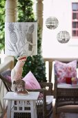 Table lamp on veranda with china cockatoo base and botanical pattern on lampshade