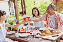 Family toasting at dining table