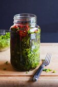 Homemade Pickled Mustard Greens in a Mason jar