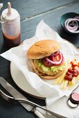 Turkey burger in a bun with chips and ketchup