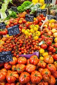 Various tomatoes on a market stand