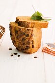 Carrot bread with pumpkin seeds, partly sliced