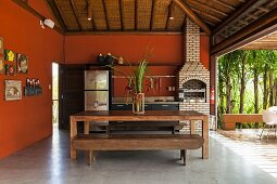 Kitchen with dining area and barbecue on terrace of beach house