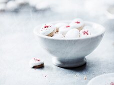 Pfeffernüsse (spiced soft gingerbread from Germany) with red sugar in a bowl