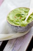 Avocado purée with pink peppercorns (close-up)
