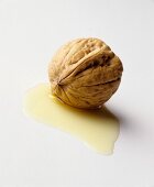 A walnut in a small pool of walnut oil